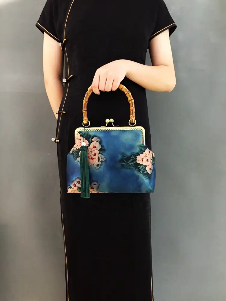 Side profile showing bag dimensions and soft construction with hasp closure.