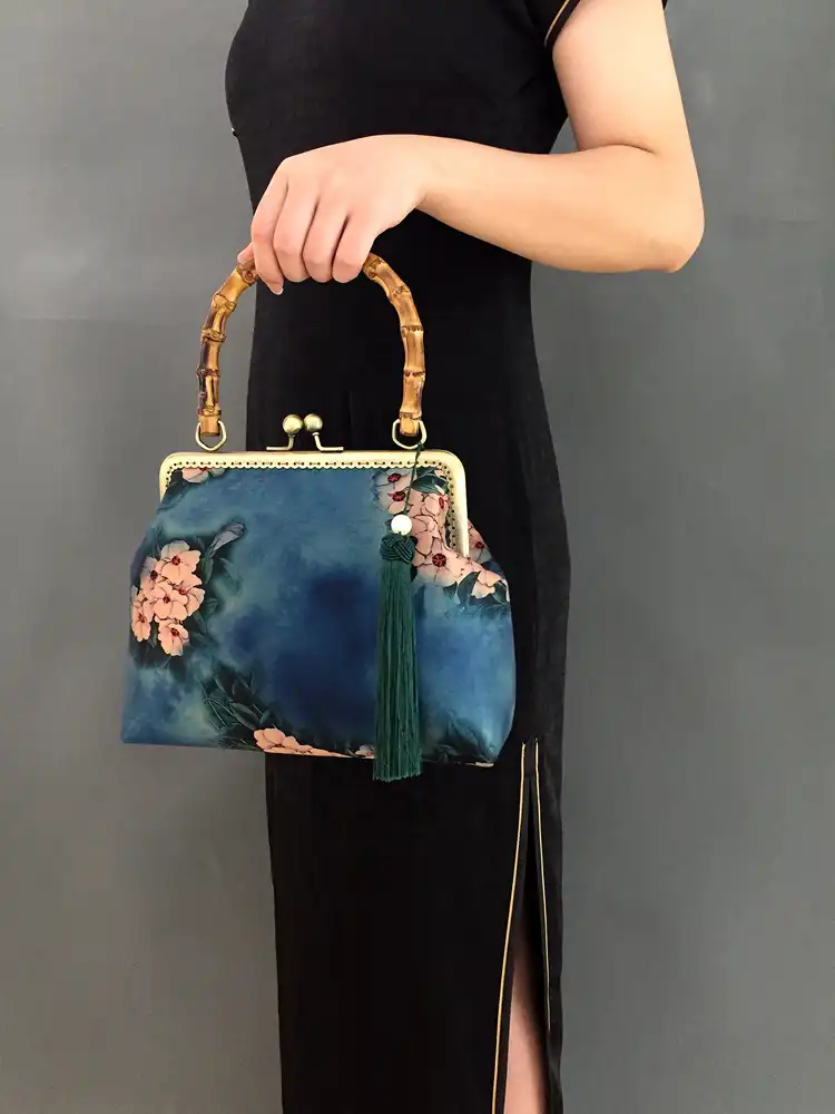 Model holding silk embroidery bag showcasing size and elegant appearance.
