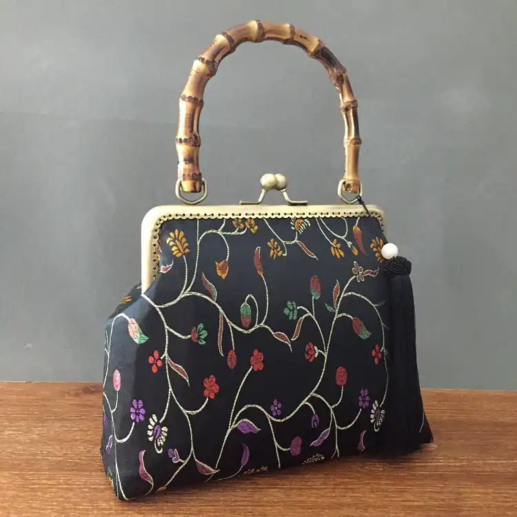 Back view of silk clutch displaying consistent embroidery pattern coverage.