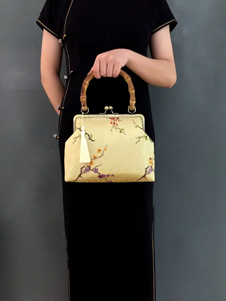 Flat lay styling with traditional Chinese accessories and embroidery bag.