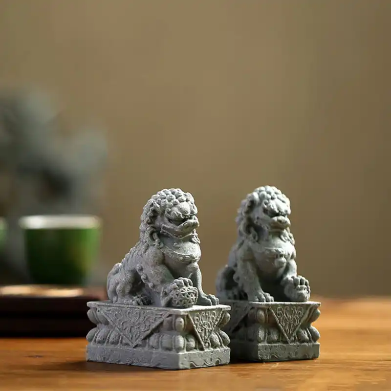 Small lion figurines arranged on office desk creating professional yet cultural decor accent.