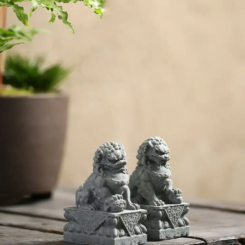 Mini stone lion ornament displaying smooth grey finish and compact tabletop friendly size.