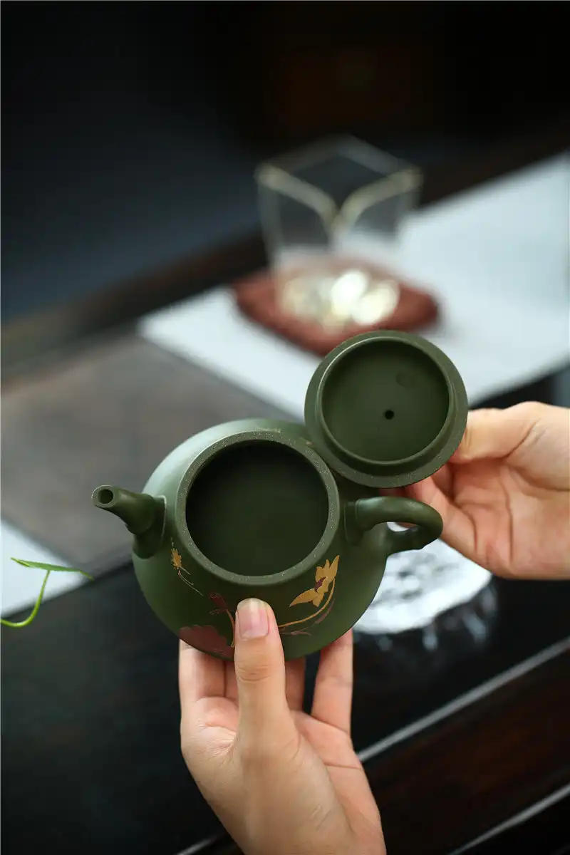 Green mud Yixing teapot collection showcasing natural clay variations and traditional craftsmanship.