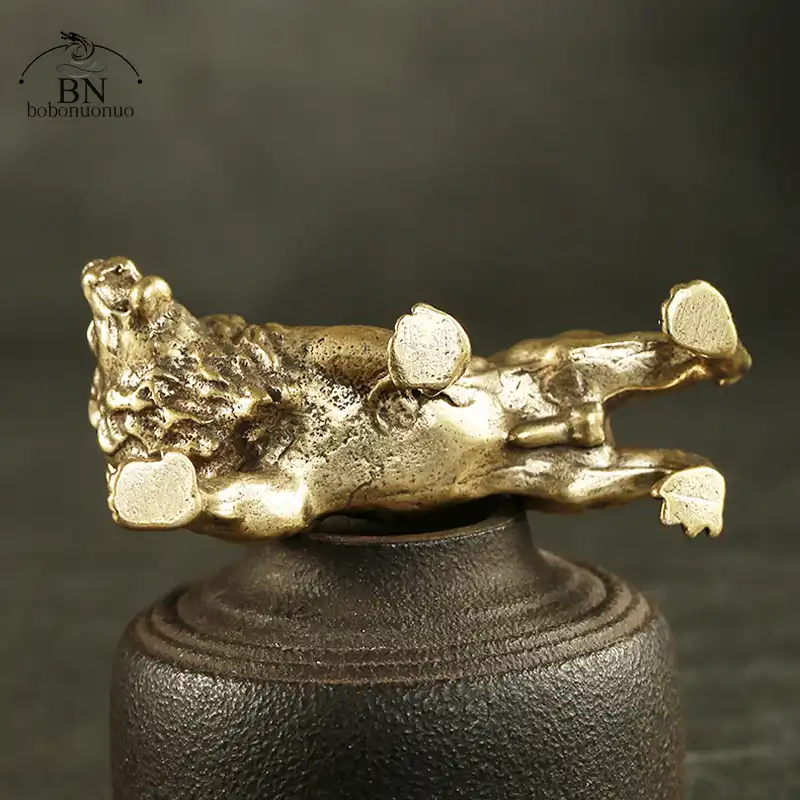 Antique bronze lion statue showing detailed copper craftsmanship with aged patina finish on white background.