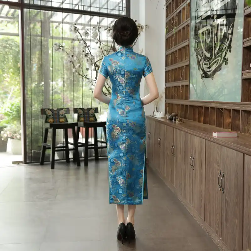 Detail shot of decorative button closures on green Chinese cheongsam traditional design.
