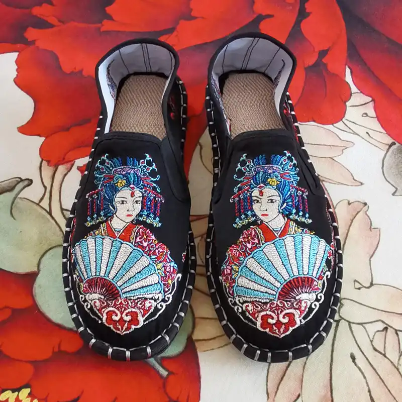 Woman wearing embroidered flat shoes with casual summer outfit in outdoor setting.
