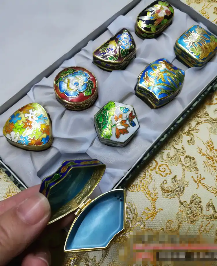 Eight piece cloisonne jewelry storage collection displaying various sizes and designs.