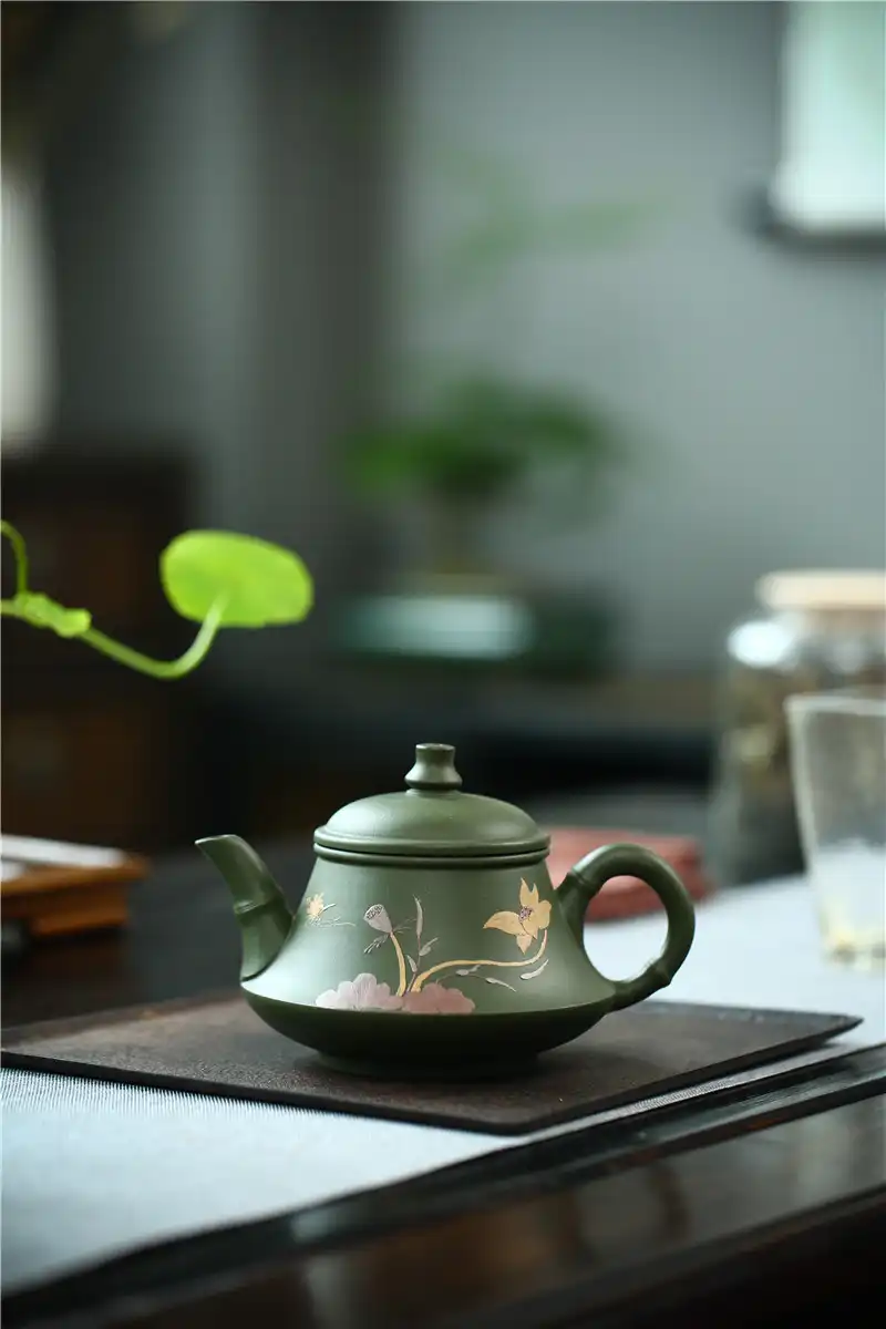 Professional tea ceremony setup featuring real handmade green mud Yixing teapot as centerpiece.