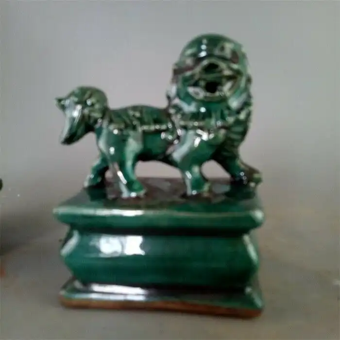 Traditional male and female foo dog pair positioned together as protective guardians for home entrance.