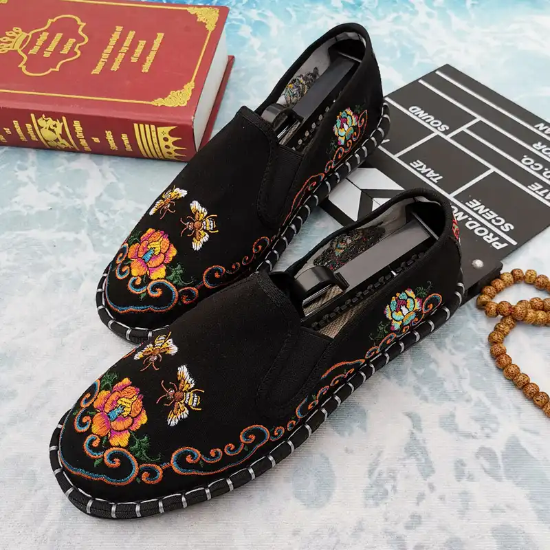 Chinese traditional embroidered women's flat shoes with intricate patterns on canvas upper.