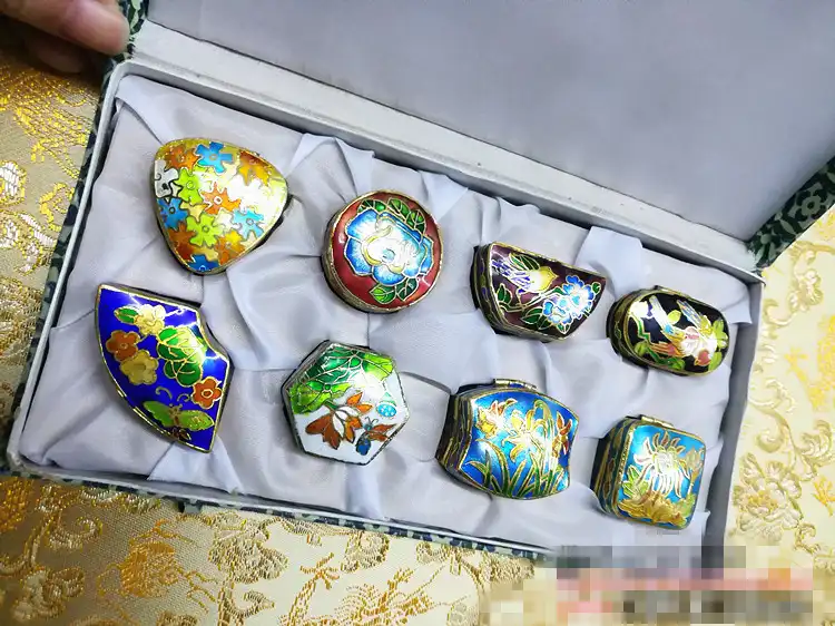 Interior view of cloisonne jewelry box showing smooth finish and secure compartments.