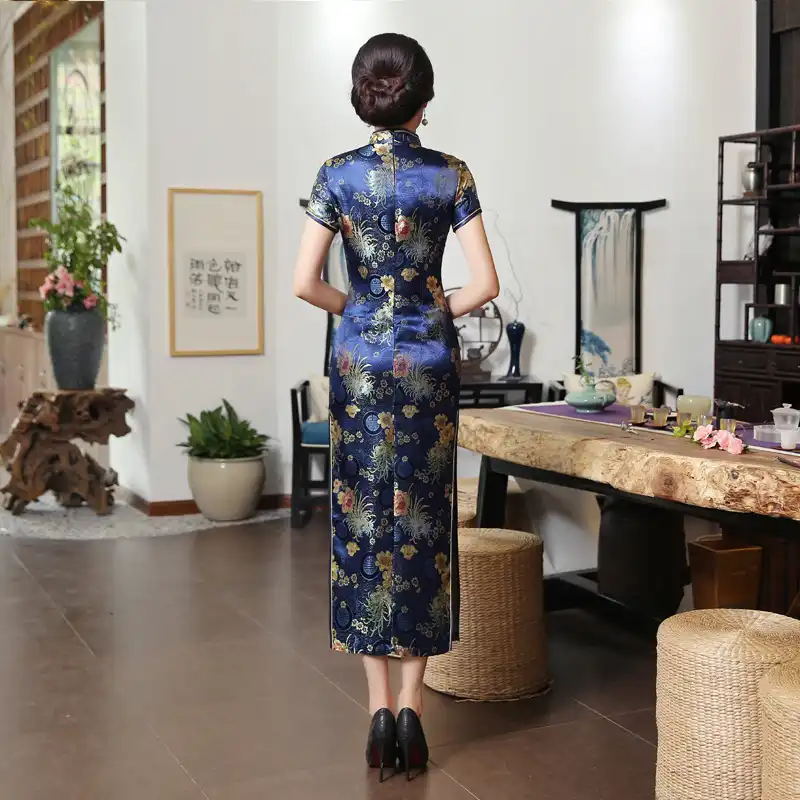 Close-up of Mandarin collar construction on green qipao dress showing quality craftsmanship.
