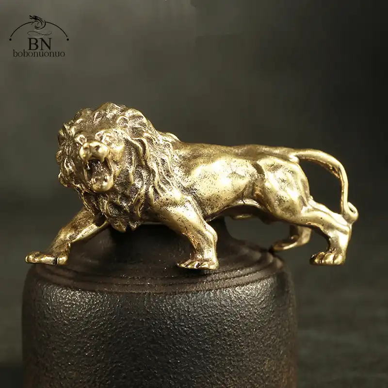 Side profile of miniature copper lion statue displaying muscular body structure and royal stance.