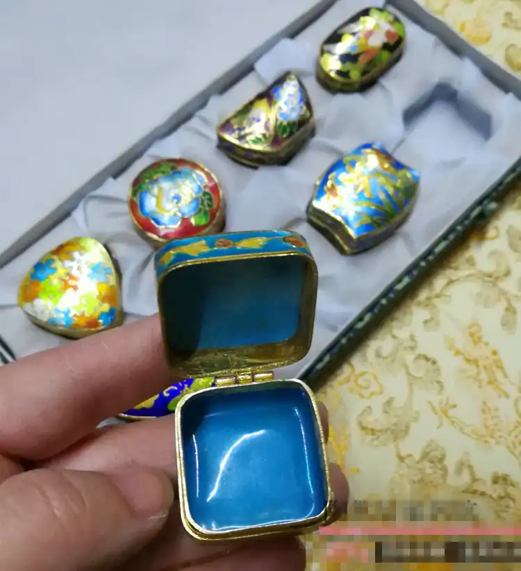 Cloisonne jewelry box being used to store rings, earrings and small precious items.