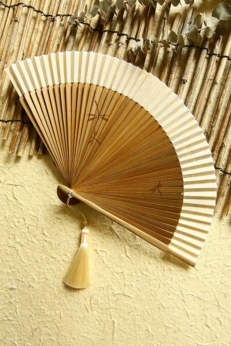 Daily use scenario showing woman carrying portable dragonfly fan for practical cooling needs.