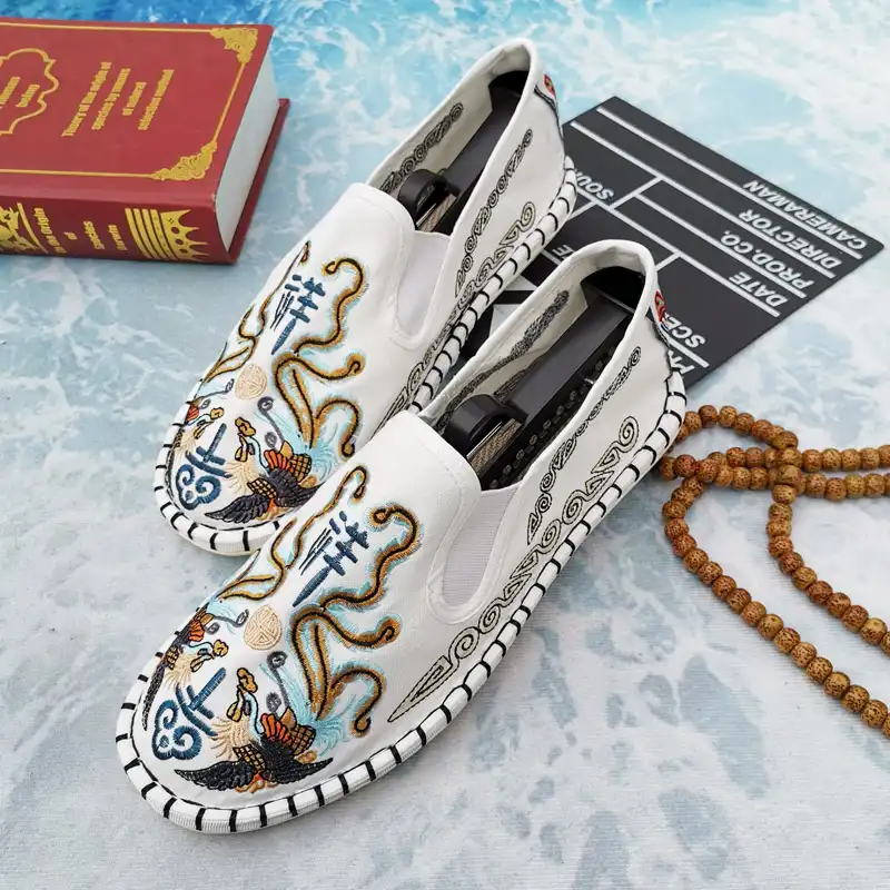 Side view of breathable slip-on loafers showing classic embroidery work and round toe design.