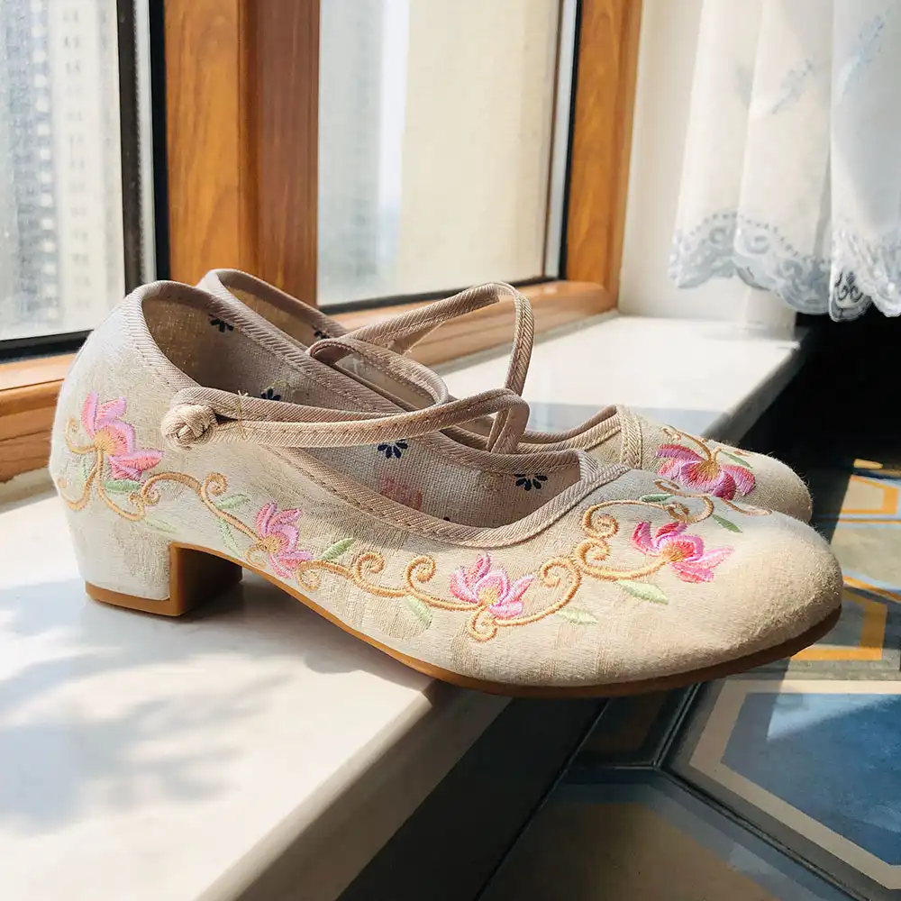 Close-up detail of intricate embroidered pattern on cotton canvas upper showing Chinese craftsmanship.