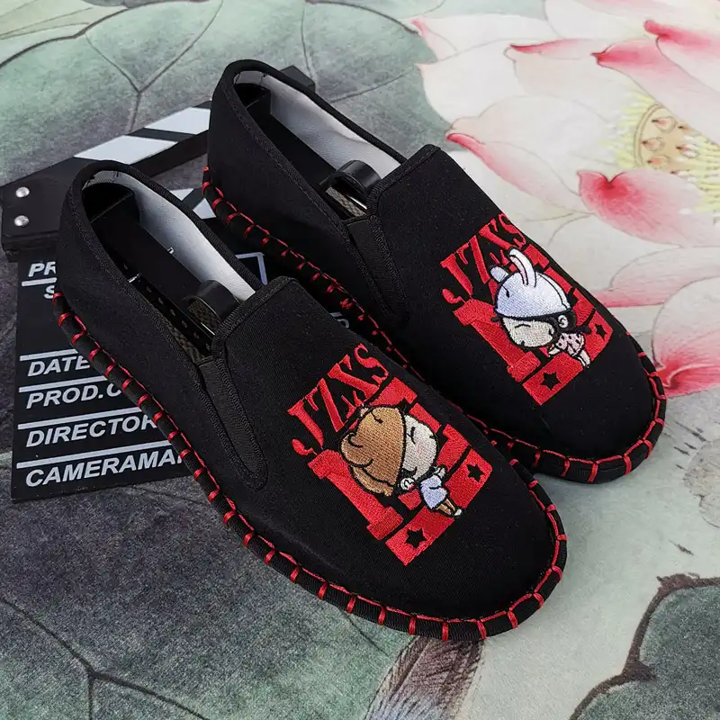 Top view of embroidered flat shoes displaying artistic needlework and ethnic styling.