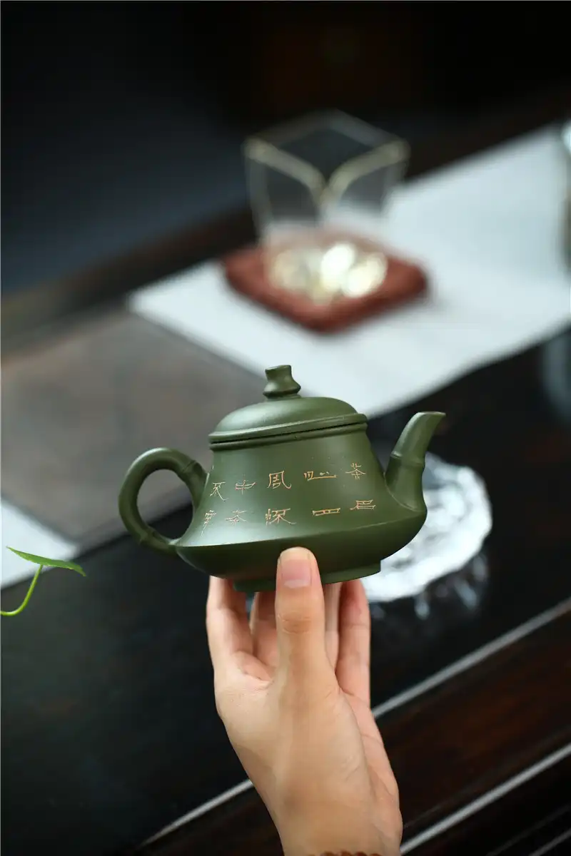 Complete Kung Fu tea set arrangement with green mud purple clay teapot and matching accessories.