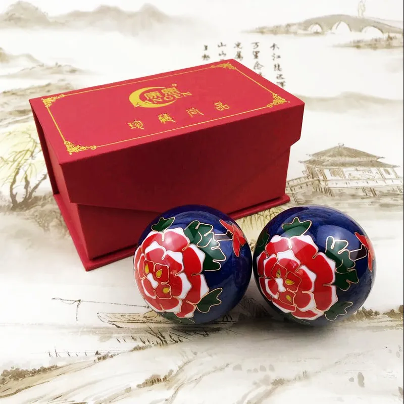 Cloisonne meditation Baoding balls with white plum blossom design on elegant red presentation box.
