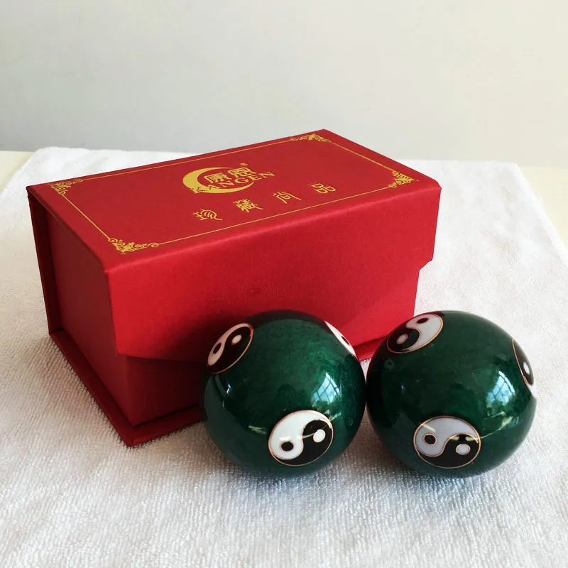 Traditional Chinese meditation balls displayed on wooden surface highlighting cultural heritage.
