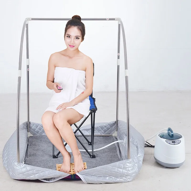 Person relaxing inside portable steam sauna enjoying therapeutic weight loss and detox session.