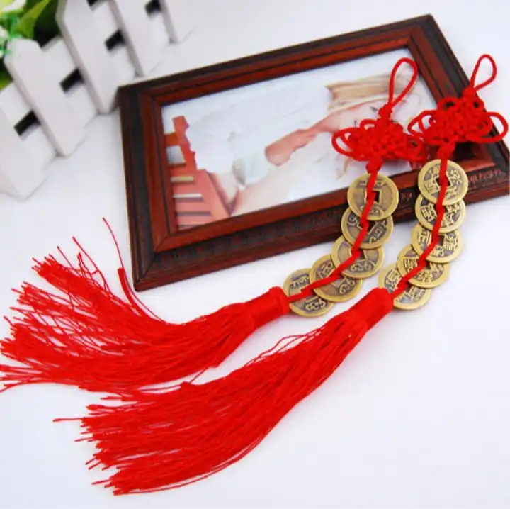 Chinese feng shui coins with handmade red endless knot hanging ornament for wealth luck.