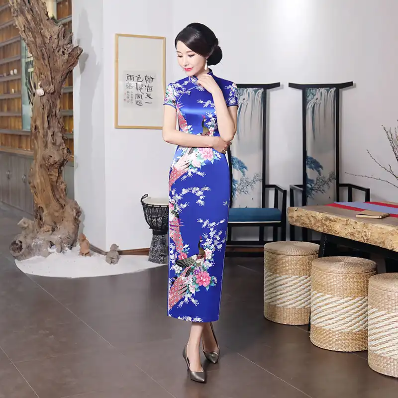 Handmade button closure detail on purple cheongsam showing traditional craftsmanship.
