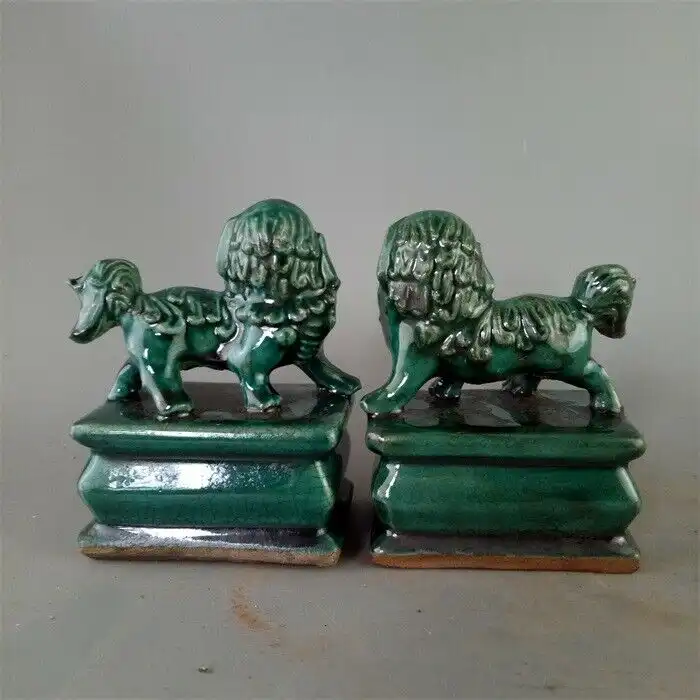 Chinese foo dog guardian lions displayed on home shelf demonstrating decorative and protective placement.