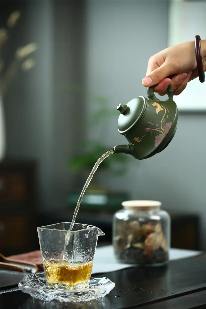 Gift presentation of real handmade green mud Yixing teapot for tea enthusiasts and collectors.