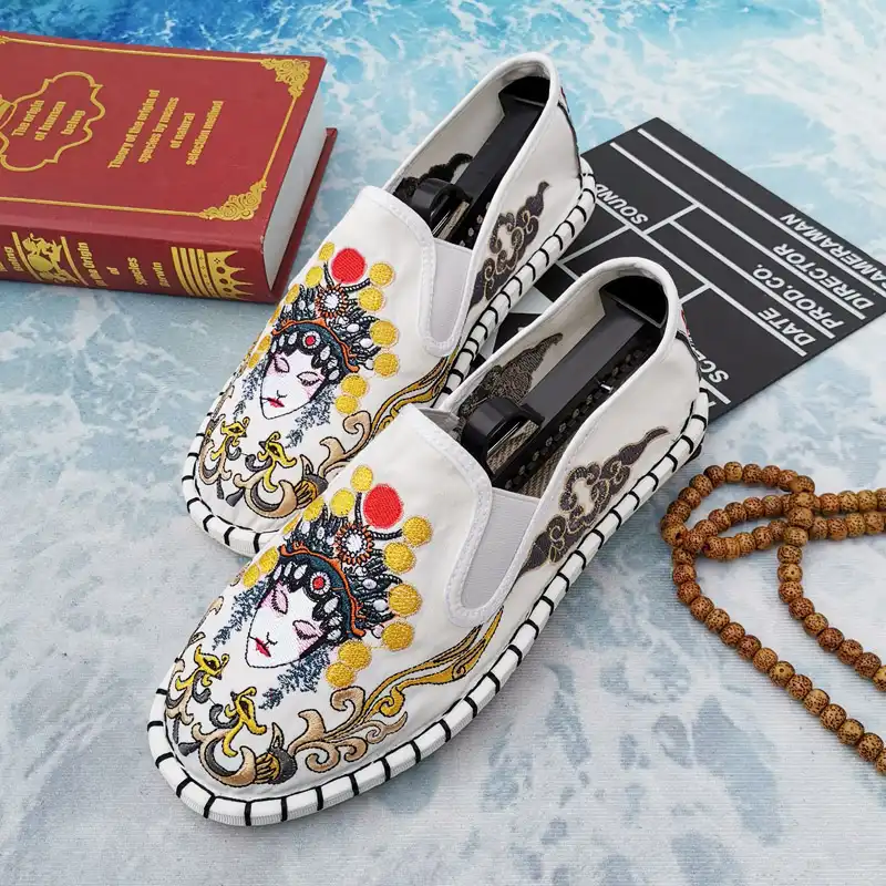 Fashion model walking in Chinese embroidered slip-on shoes on city street.