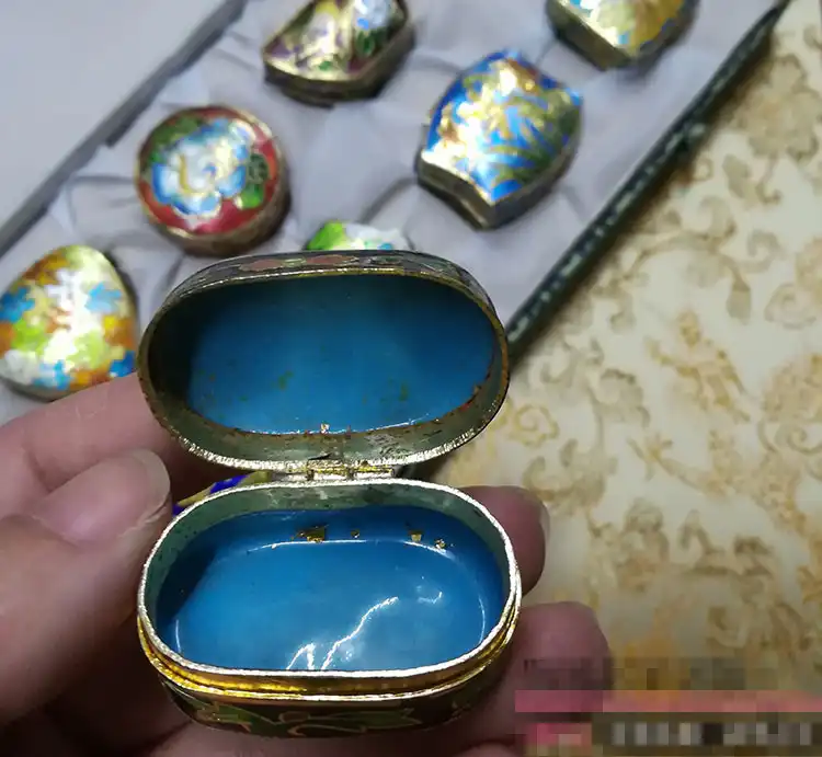 Side angle of cloisonne enamel boxes highlighting copper construction and craftsmanship.