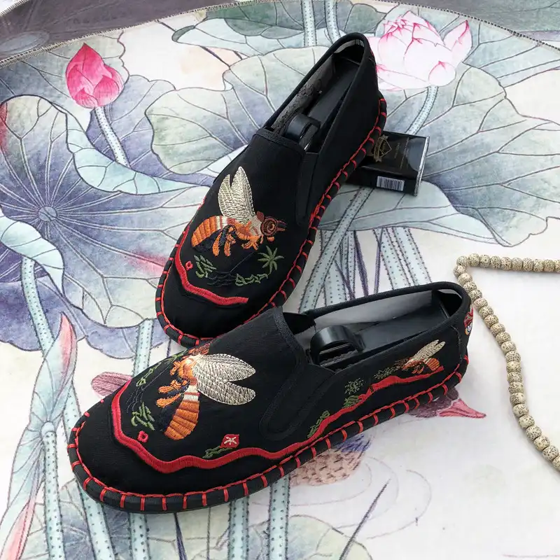 Close-up of embroidered shoe heel area showing quality stitching and construction.