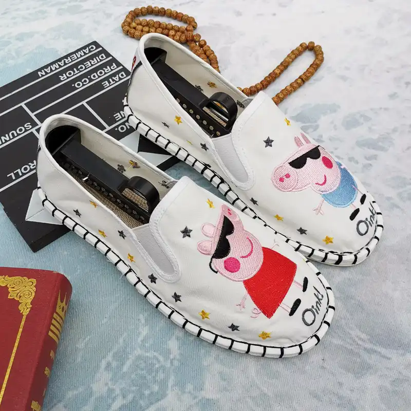 Traditional embroidered loafers paired with modern jeans and casual top outfit.