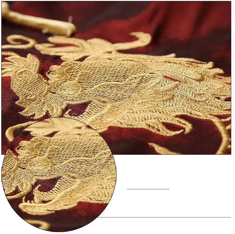 Close-up detail of luxury golden dragon embroidery pattern on black fabric surface.