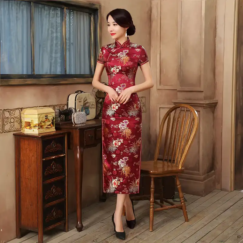 Back view of green Chinese cheongsam displaying traditional button closures and dress silhouette.