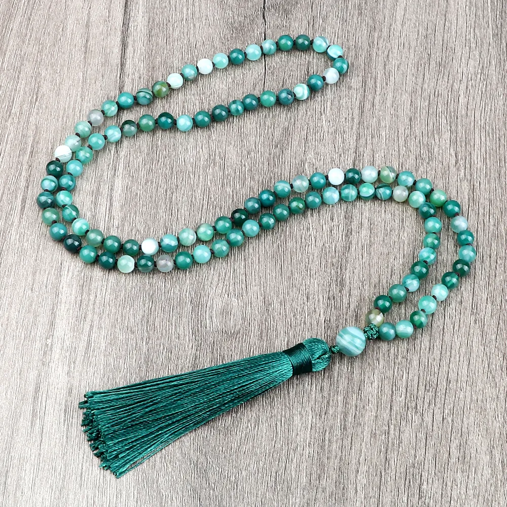 Green onyx mala beads laid flat showing complete circle of 108 prayer beads.
