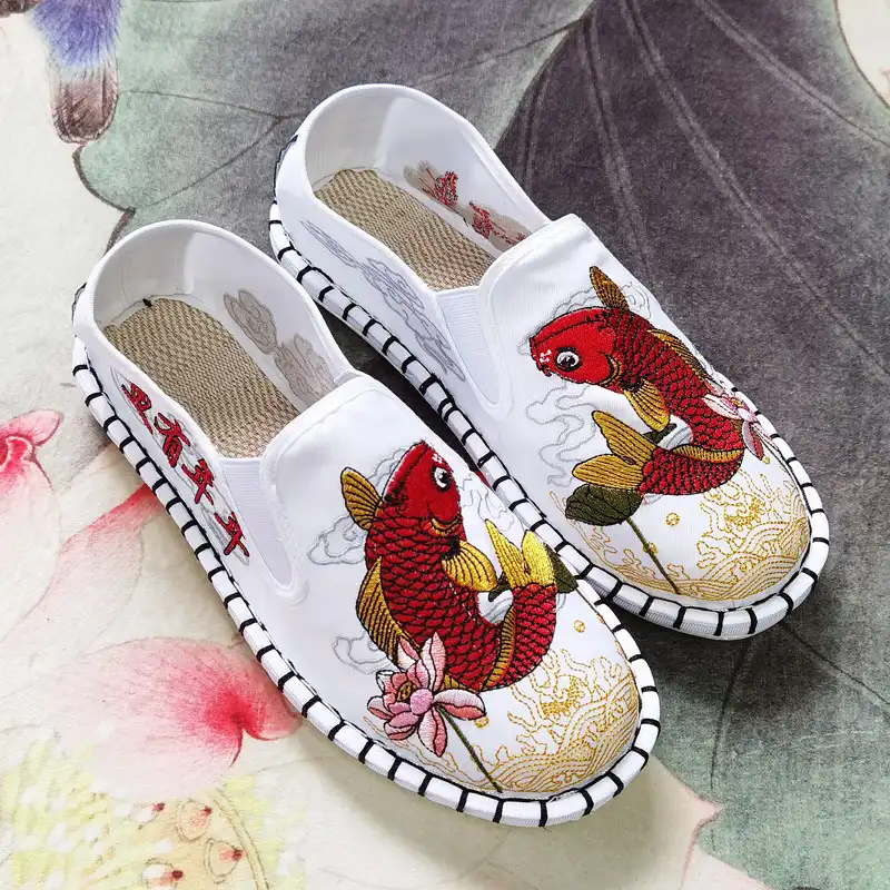 Product packaging showing traditional embroidered flat shoes ready for shipping.