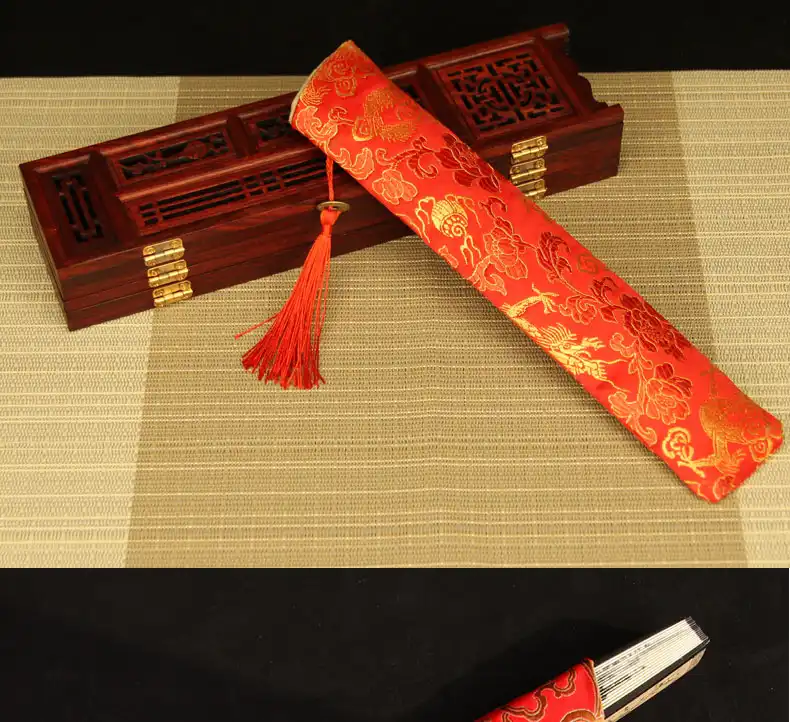 Leisure activity demonstration of Japanese fan used during outdoor relaxation.