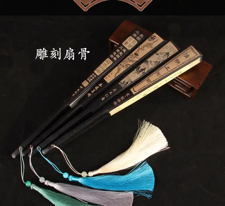 Outdoor event usage of durable Japanese fan providing practical cooling solution.