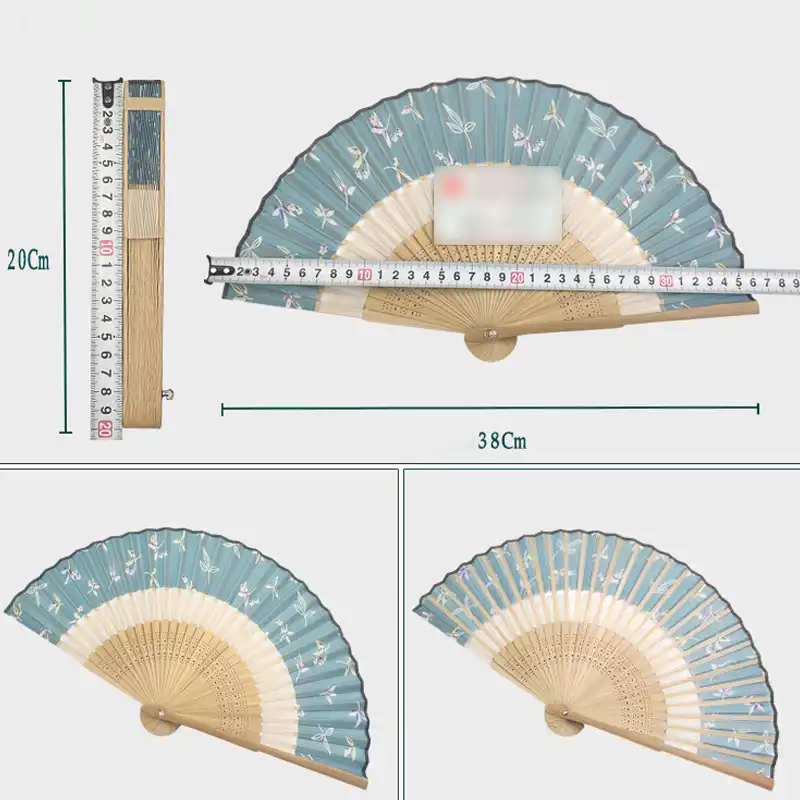 Japanese vintage silk folding fan with decorative tassel displayed fully open showing craftsmanship.