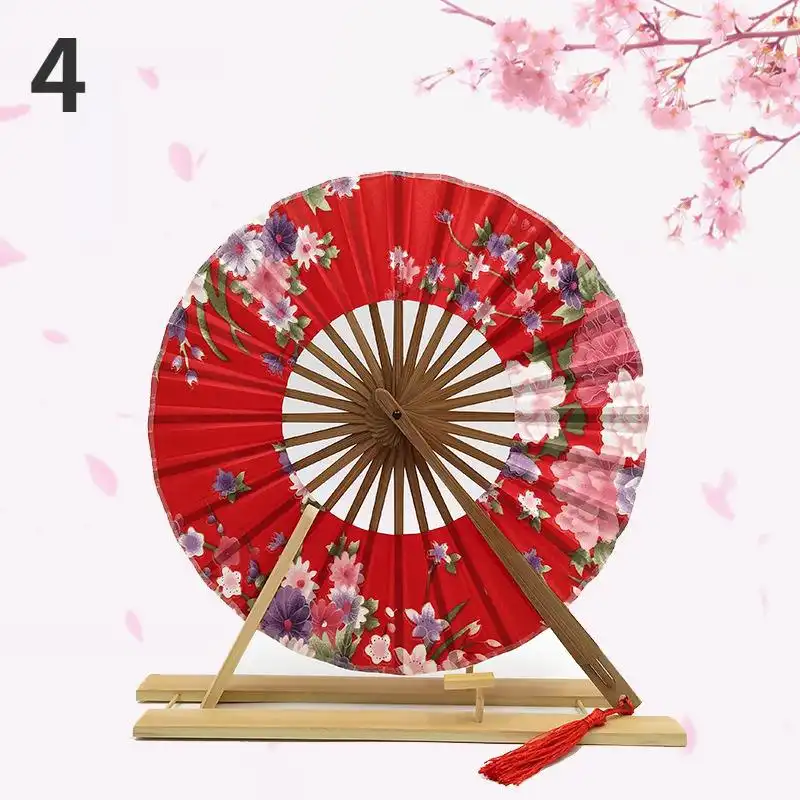 Multiple Japanese round fans arranged showing windmill pattern and design variations.