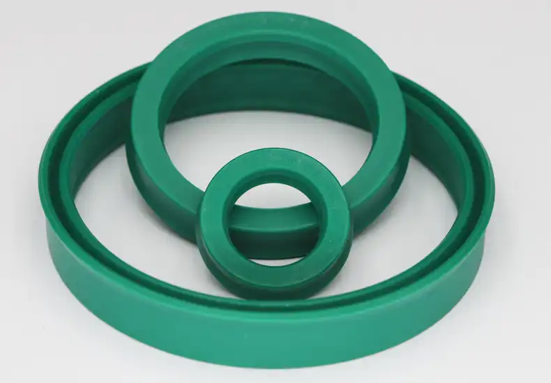BS type hydraulic cylinder piston rod seal in green polyurethane showing grooved design.