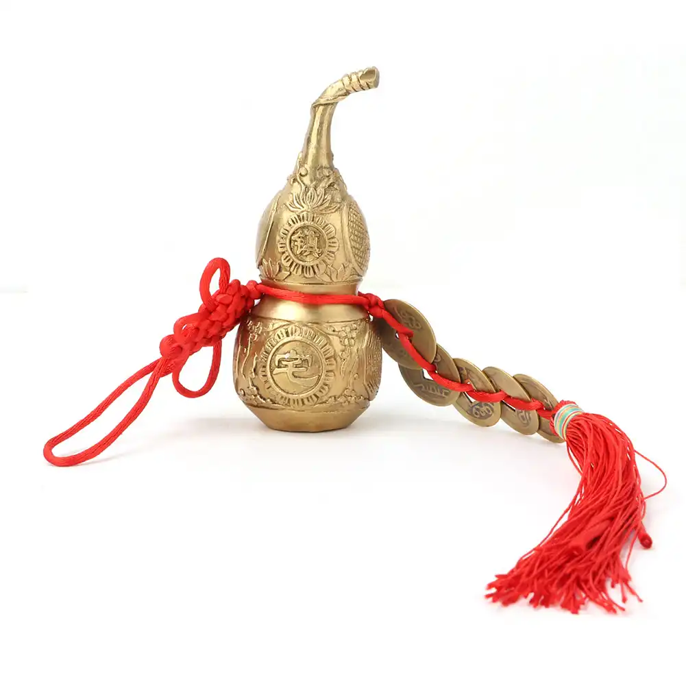 Traditional feng shui brass gourd ornament in living room setting for prosperity and home decor.