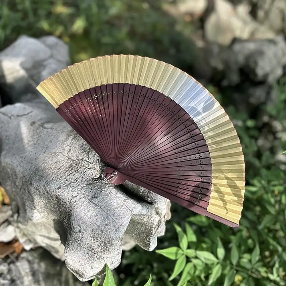 Japanese silk bamboo folding fan with color changing feature displayed fully open.
