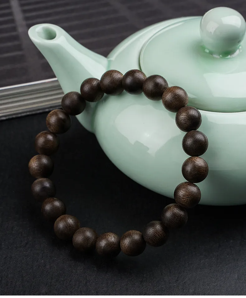 Natural wooden prayer bracelet arranged in circular pattern displaying bead consistency.
