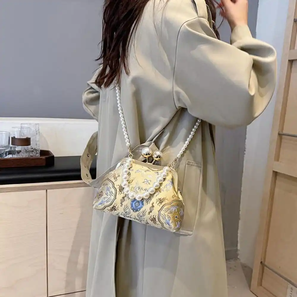 Side view of silk clutch bag showing shell shape design and premium construction quality.