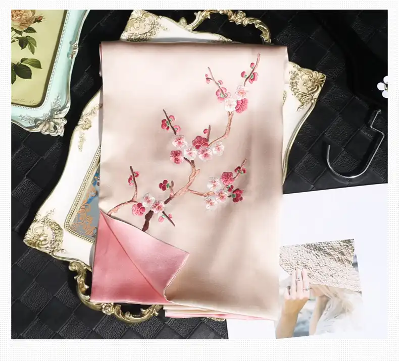 Traditional Chinese floral embroidery on silk showing delicate stitching and color gradation.