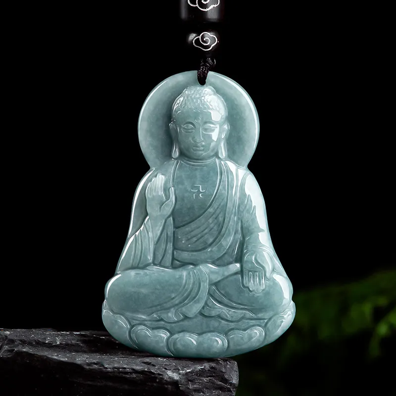 Natural jade Buddha pendant under light showing vitreous luster and semi-transparent quality.