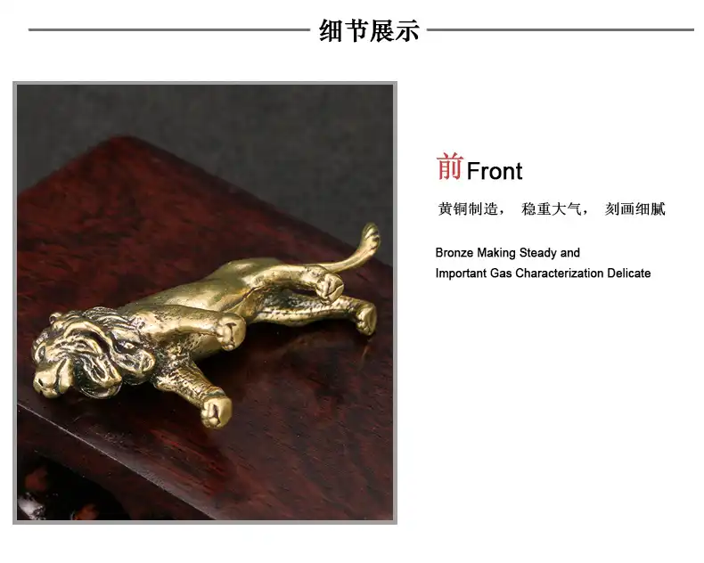 Lion figurine positioned on wooden desk next to books creating elegant office decor scene.